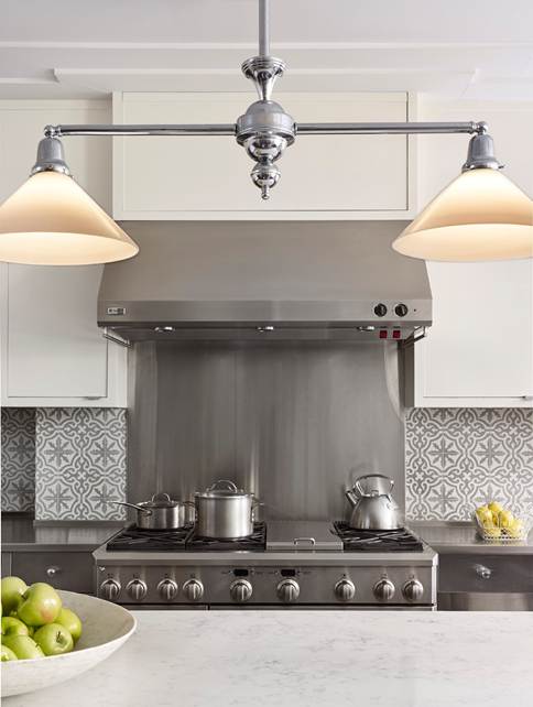 A picture of a kitchen stove and two lamps in a new historical home