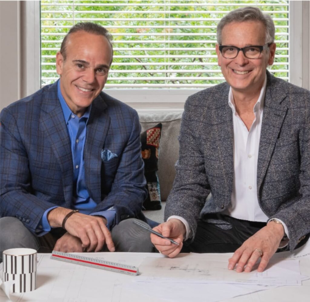 A picture of a general contractor and an architect at a draft table